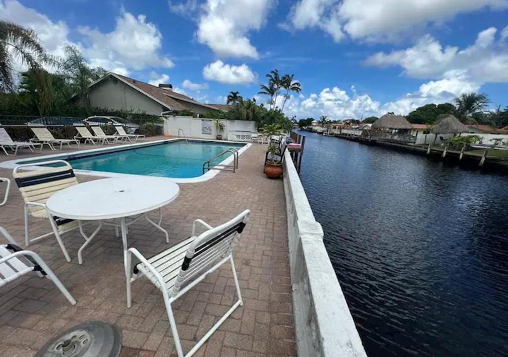 Coral Ridge Isles House | Great room with swimming pool and great views