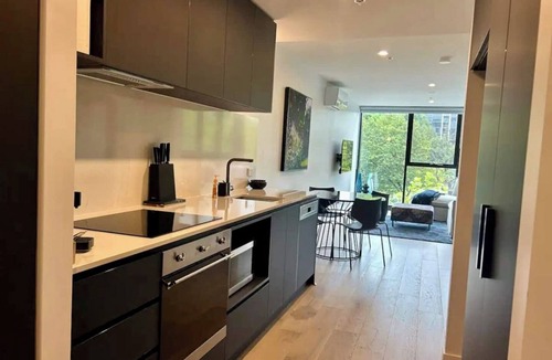 Reid Apartment | Stay in the heart of Canberra in style. Enjoy resort-style pools, rooftop gardens, and a private terrace. Perfectly positioned opposite Canberra Center, this modern retreat features secure parking, high-speed WiFi, and a fully equipped kitchen!