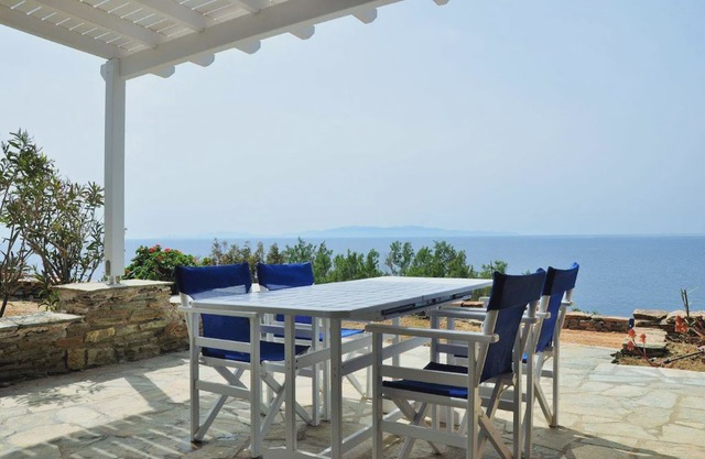 Windmill and houses by the sea / Stavros Bay